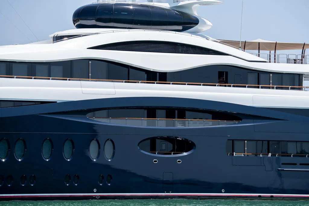 Close-up of a blue and white luxury superyacht.