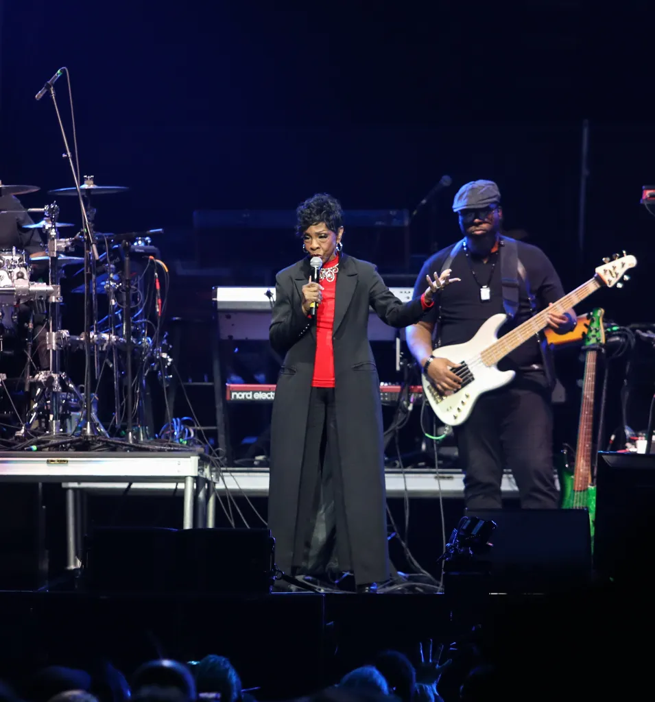 Stephanie Mills speaking into a microphone on stage during 