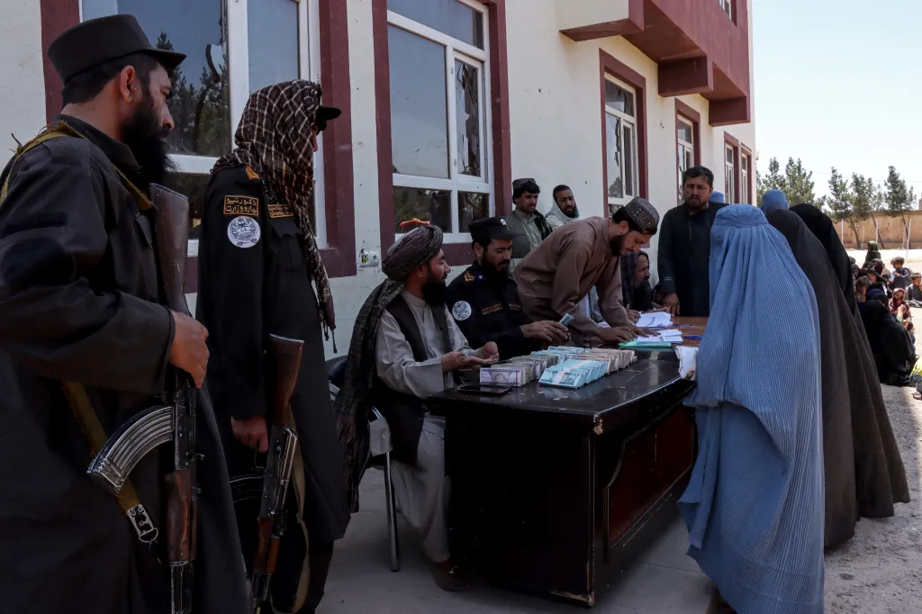 Afghan women and youths receive cash assistance from Taliban authorities and the anti-narcotics police department in Herat on May 24, 2026. 