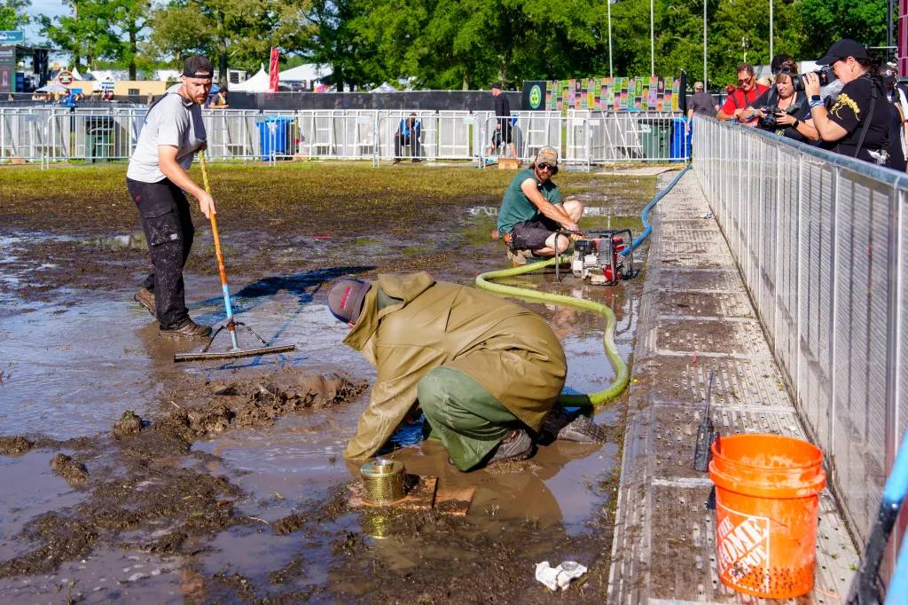 Volunteers cleaning up mud at the Bonnaroo Music and Arts Festival.