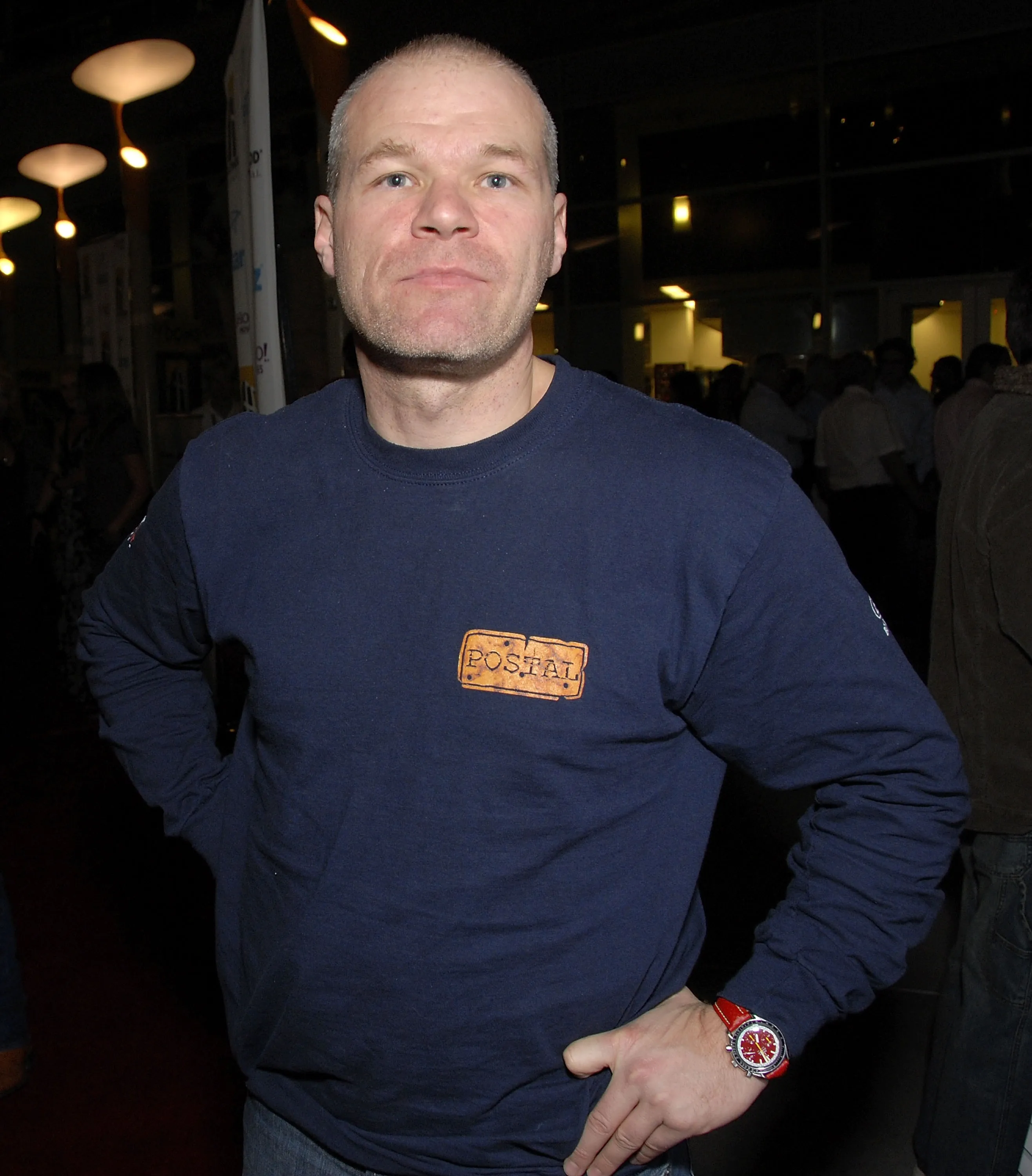 A man in a navy blue shirt with a 