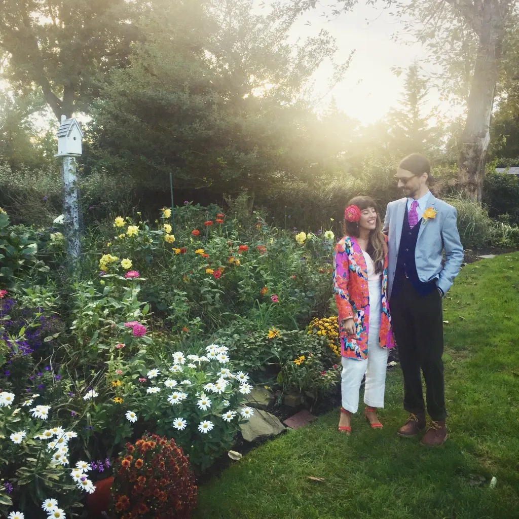 Julie Angelicola and Stephen pose together in a lush garden.
