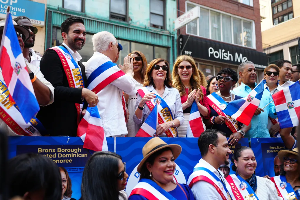 New York City Mayor Zohran Mamdani, left, with U.S. Rep. Adriano Espaillat, at right wearing an aqua colored shirt, during a ribbon cutting ceremony ahead of the 44th annual National Dominican Day Parade on Sunday, August 9, 2026, in Manhattan, N.Y. 