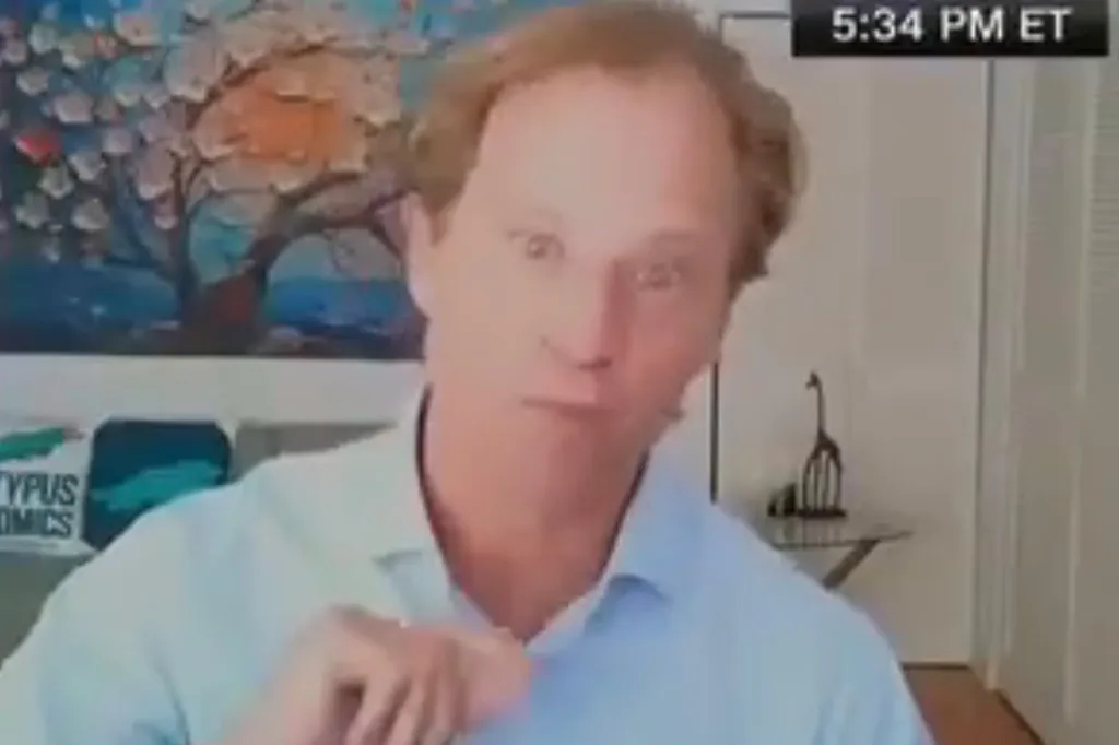 Justin Wolfers, a man with light brown hair, points his finger at the camera while speaking.
