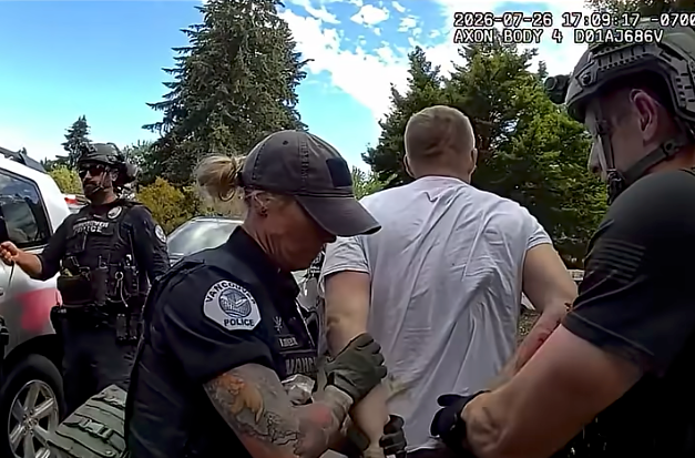 Police officers arresting an individual.
