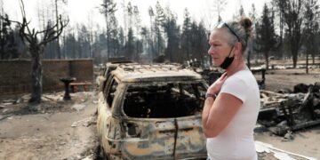 They fled by boat to the middle of Lake Spokane as wildfires closed in