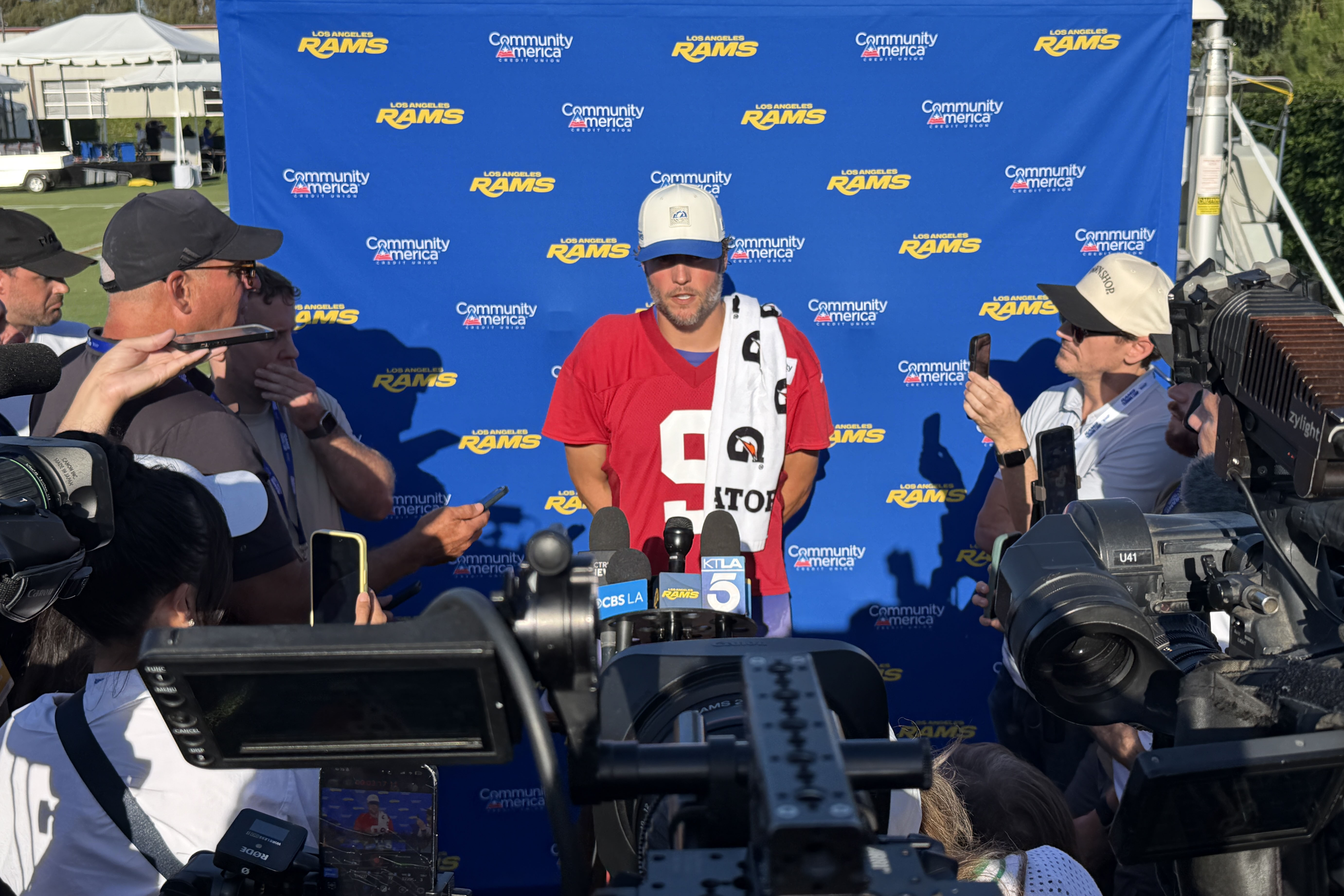 Matthew Stafford in front of podium.