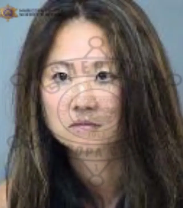 Mugshot of a woman with long dark hair.