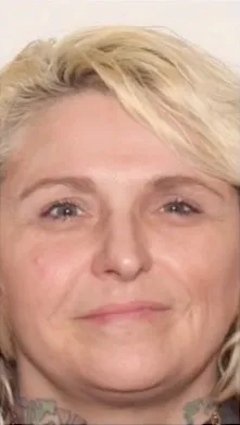 Portrait of a smiling woman with blonde hair.