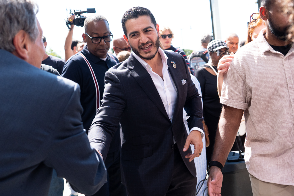 Abdul El-Sayed shakes hands with a man after winning the Democratic nomination for U.S. Senate in Michigan.