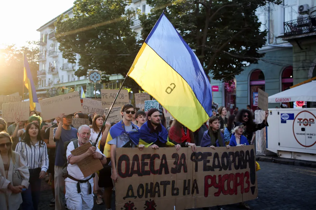 Activists hold placards and Ukrainian flags during a rally on Deribasovskaya Street in Odessa on Sunday, August 16, 2026.