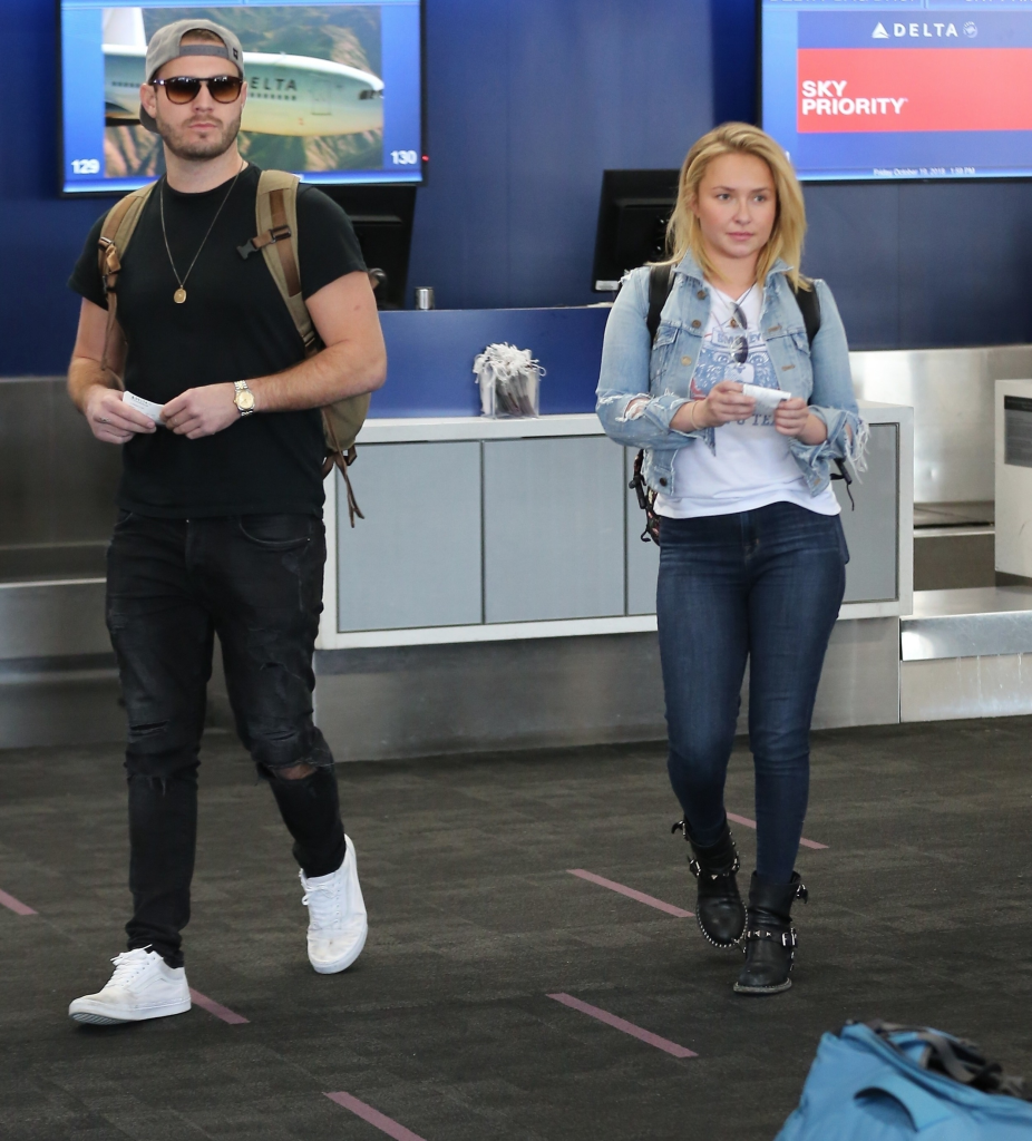 Brian Hickerson and Hayden Panettiere walking through an airport terminal.
