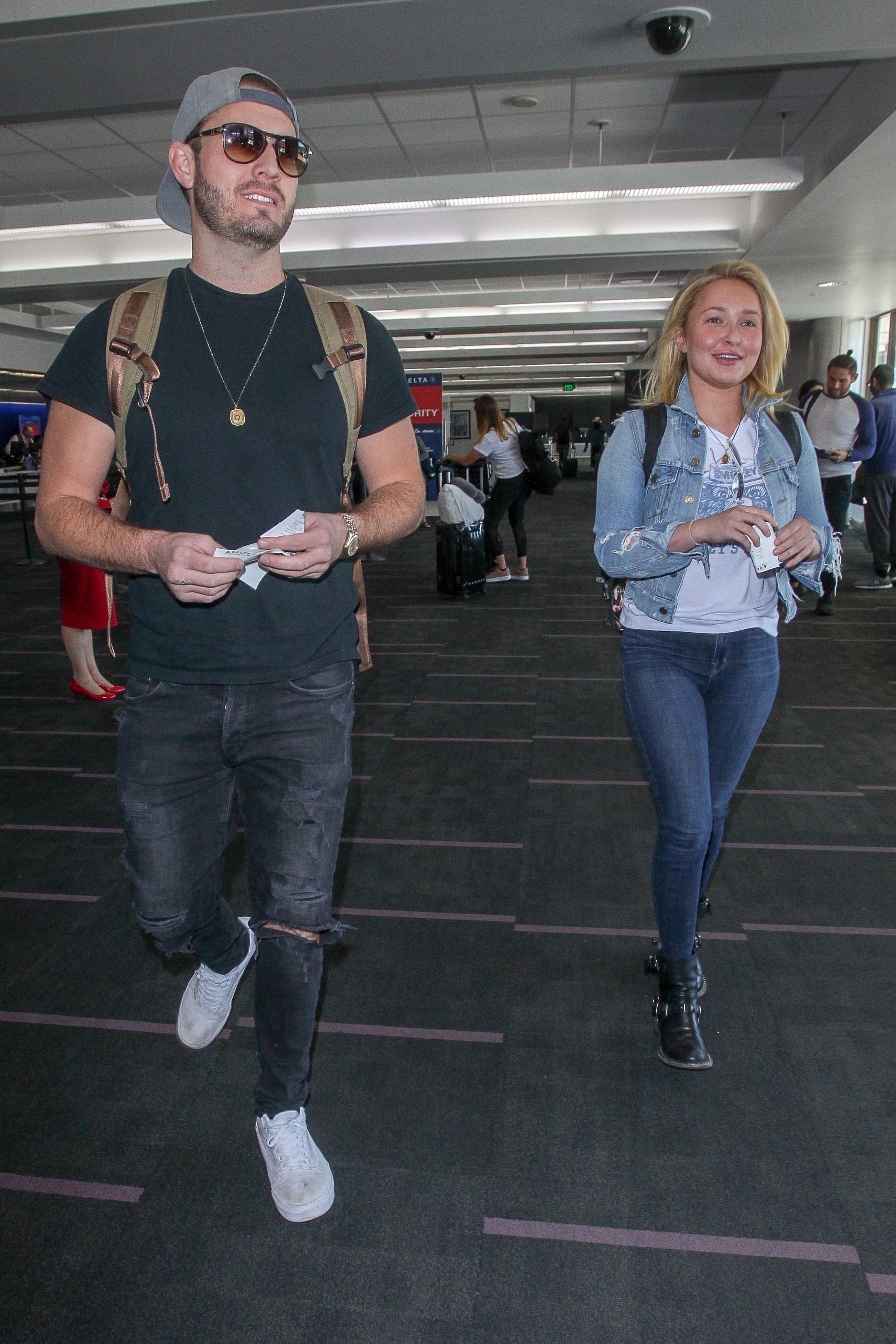 Hayden Panettiere and Brian Hickerson smiling at LAX airport.