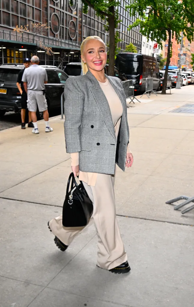 Hayden Panettiere in New York City, wearing a plaid blazer, tan pants, and carrying a black bag.