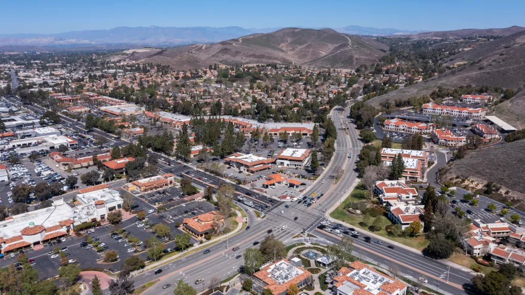 Aerial view of downtown Thousand Oaks, California, showing roads, buildings, and surrounding hills.