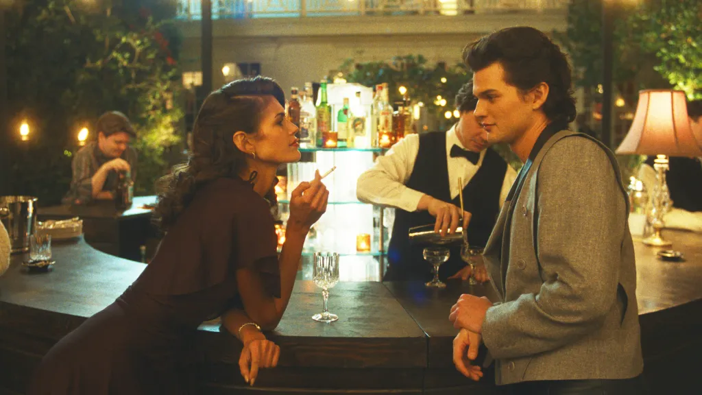 Kaia Gerber as Susan with a cigarette and Homer Gere as Robert Mallory at a bar.