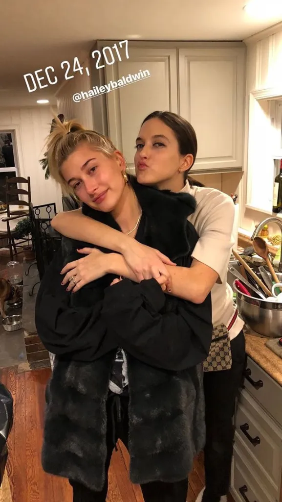 Alaia Baldwin hugging Hailey Bieber.