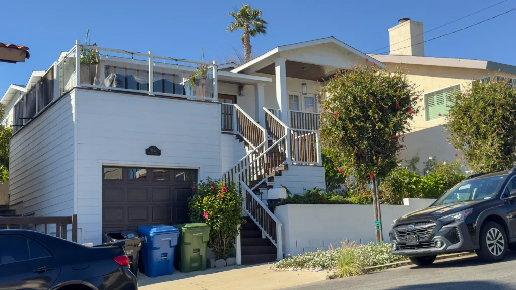 Home of Alberto Carvalho following an FBI raid, with a box of Japanese whiskey on the porch.