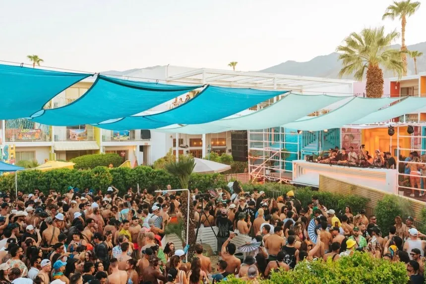 Large crowd of people gathered at a Splash House event with a DJ playing on a stage.