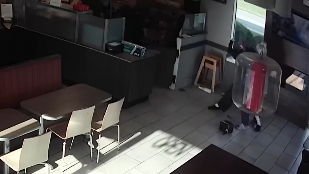 Security footage of a woman falling to the floor after a fight in a Tim Hortons.