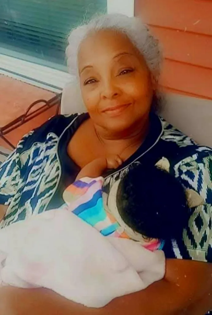 Anita Grayson holding a baby.