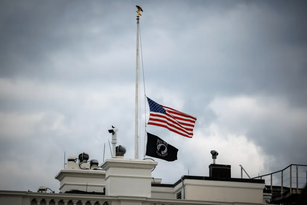 The American flag and a POW/MIA flag fly at half-staff over the White House.
