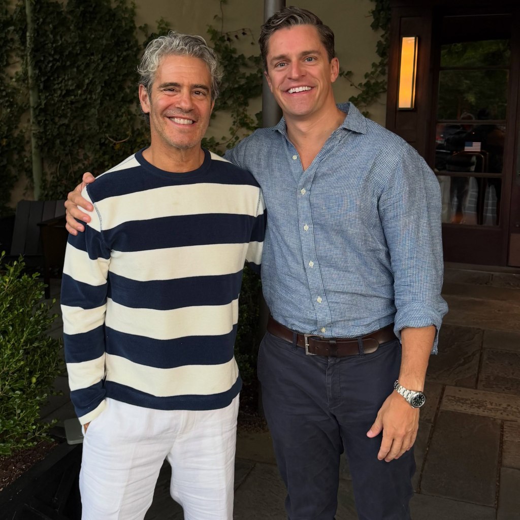 Andy Cohen and Kevin Sobieski smiling together, with Sobieski's arm around Cohen.