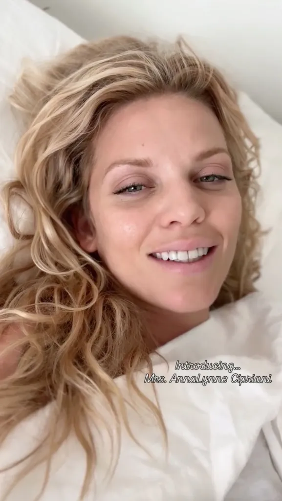 Annalynne McCord smiling in bed with text 