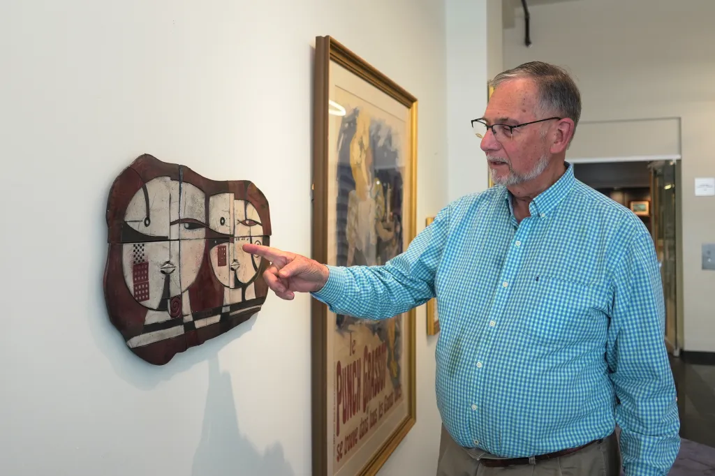 Bill DeLind shows off the spot where the Picasso sketch was displayed when it was stolen from his shop.