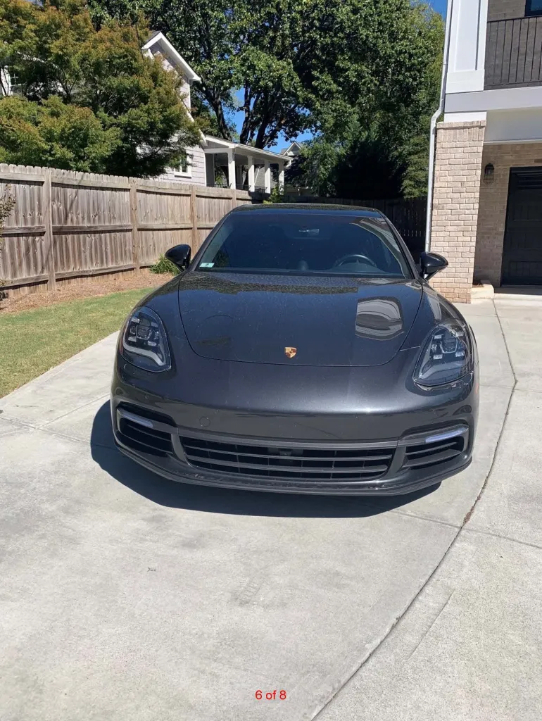 A gray Porsche Panamera parked in a driveway.