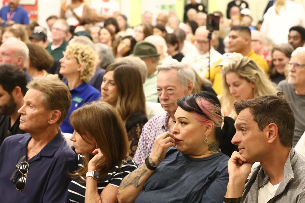 Audience members watching a debate between Los Angeles Mayor Karen Bass and City Councilmember Nithya Raman.