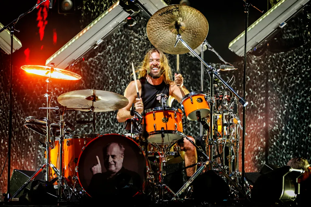 Taylor Hawkins of Foo Fighters performs on stage while drumming.