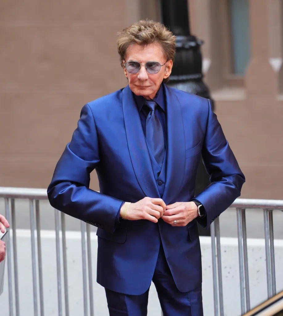 Barry Manilow in a blue suit and sunglasses.