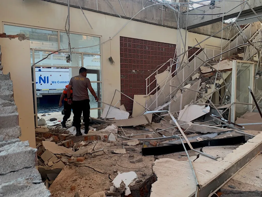 First responders search for victims inside a destroyed building in Maumere on Aug. 15, 2026.