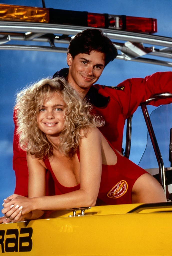 Billy Warlock and Erika Eleniak in character as lifeguards in Baywatch.