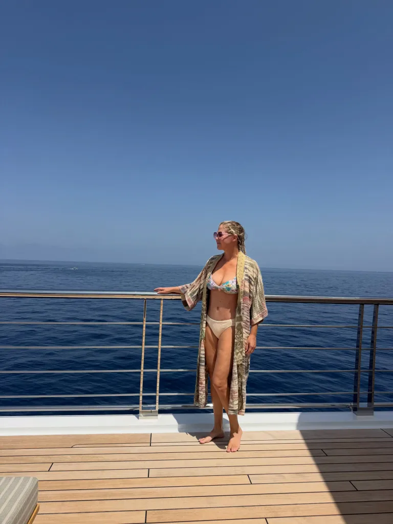 Amy Schumer in a bikini and cover-up on a yacht.