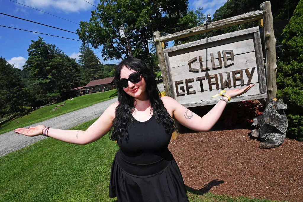 Marissa Matozzo posing in front of the Camp Getaway sign.