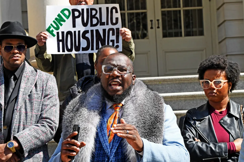 Reverend Kevin McCall speaks to activists and neighborhood leaders with a 
