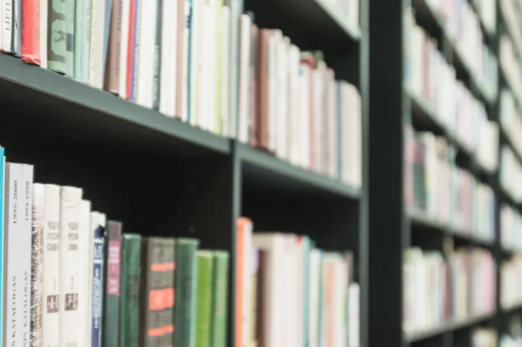 Side view of bookshelves packed with books in a library or archive.