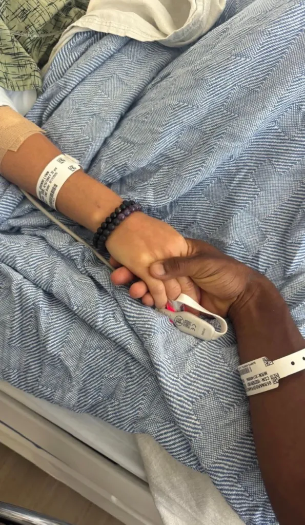 Johnni Bufkin Bernardo and Victor Bernardo holding hands while recovering in the hospital.