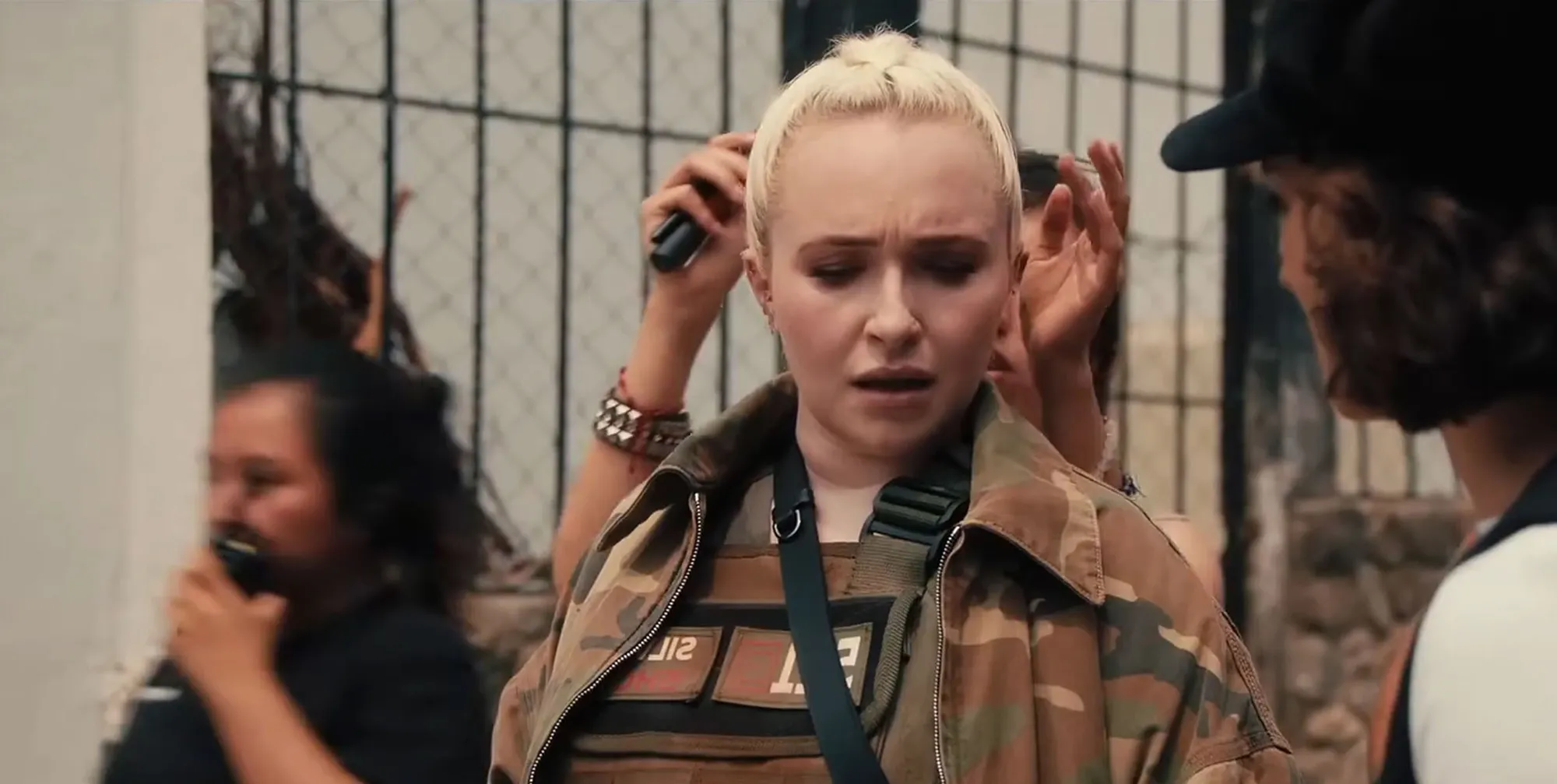 Hayden Panettiere with blonde hair wearing a camouflage jacket.