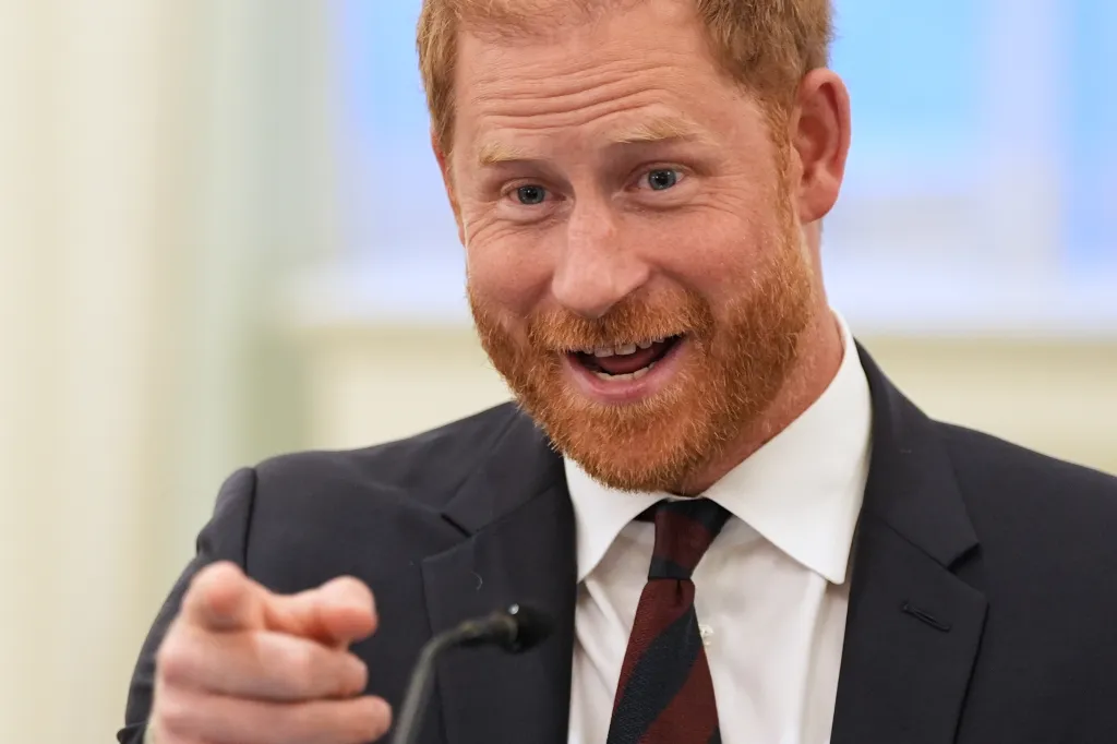 Prince Harry, Duke of Sussex, speaks at a roundtable about support for veterans, pointing towards the camera.