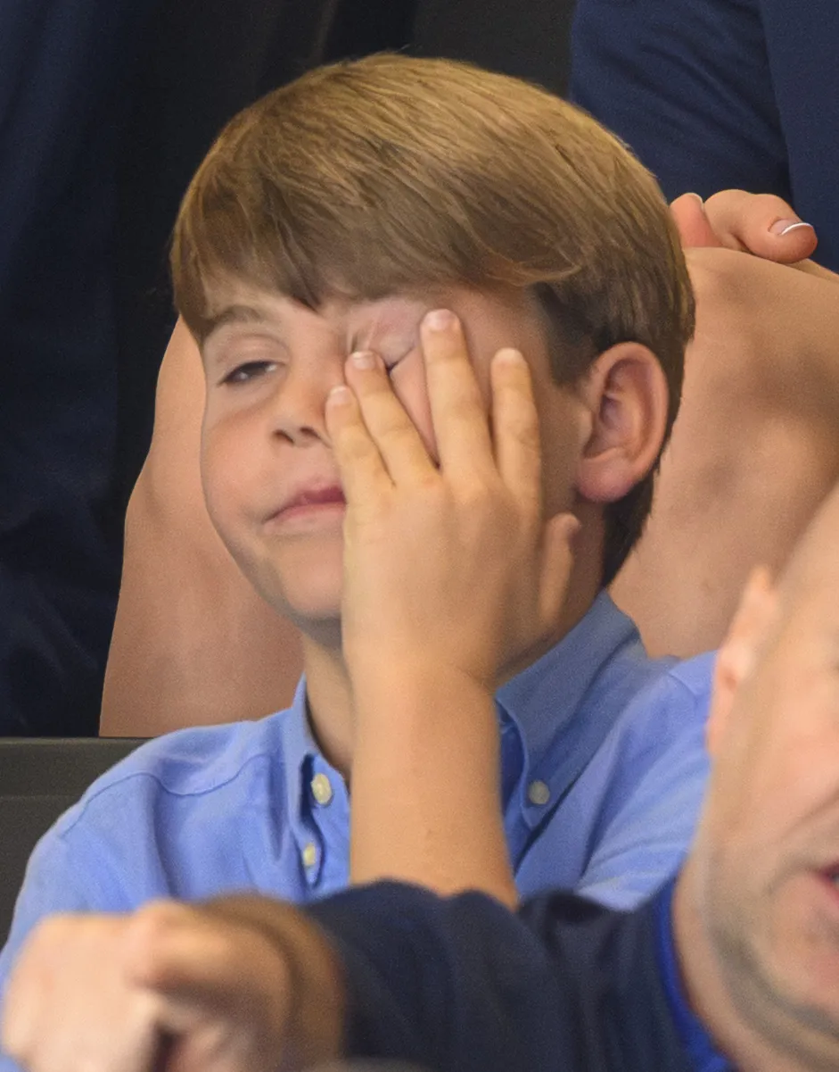 Prince Louis covers his face with his hand while watching the Commonwealth Games.