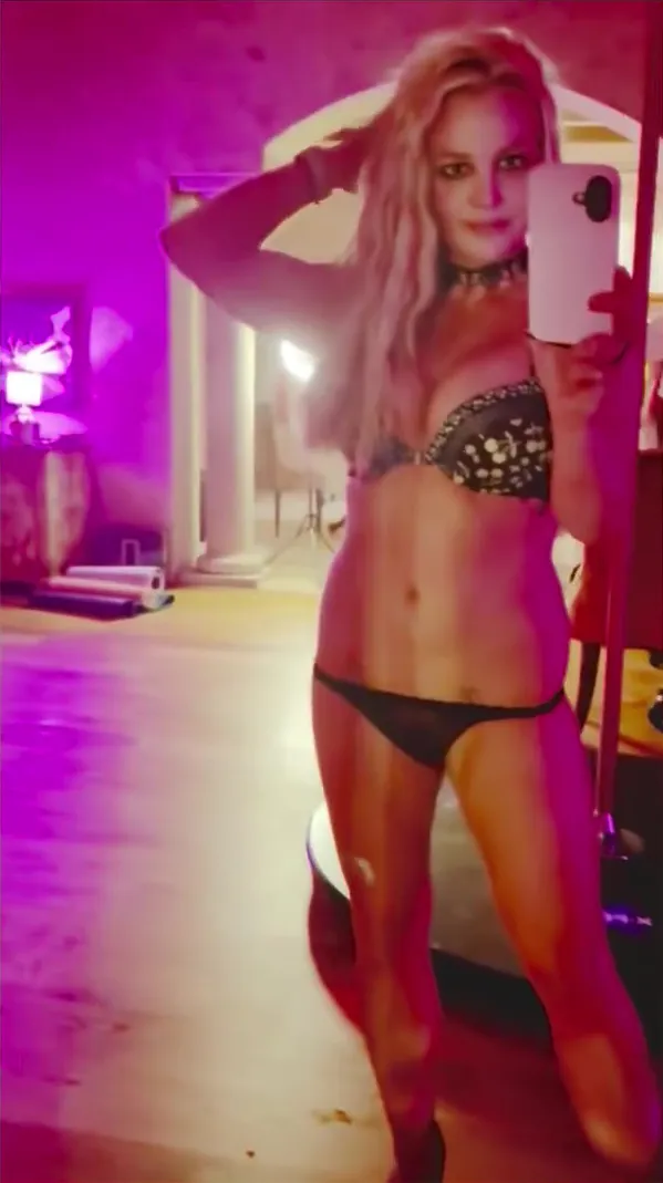 Britney Spears models black lingerie while taking a mirror selfie.