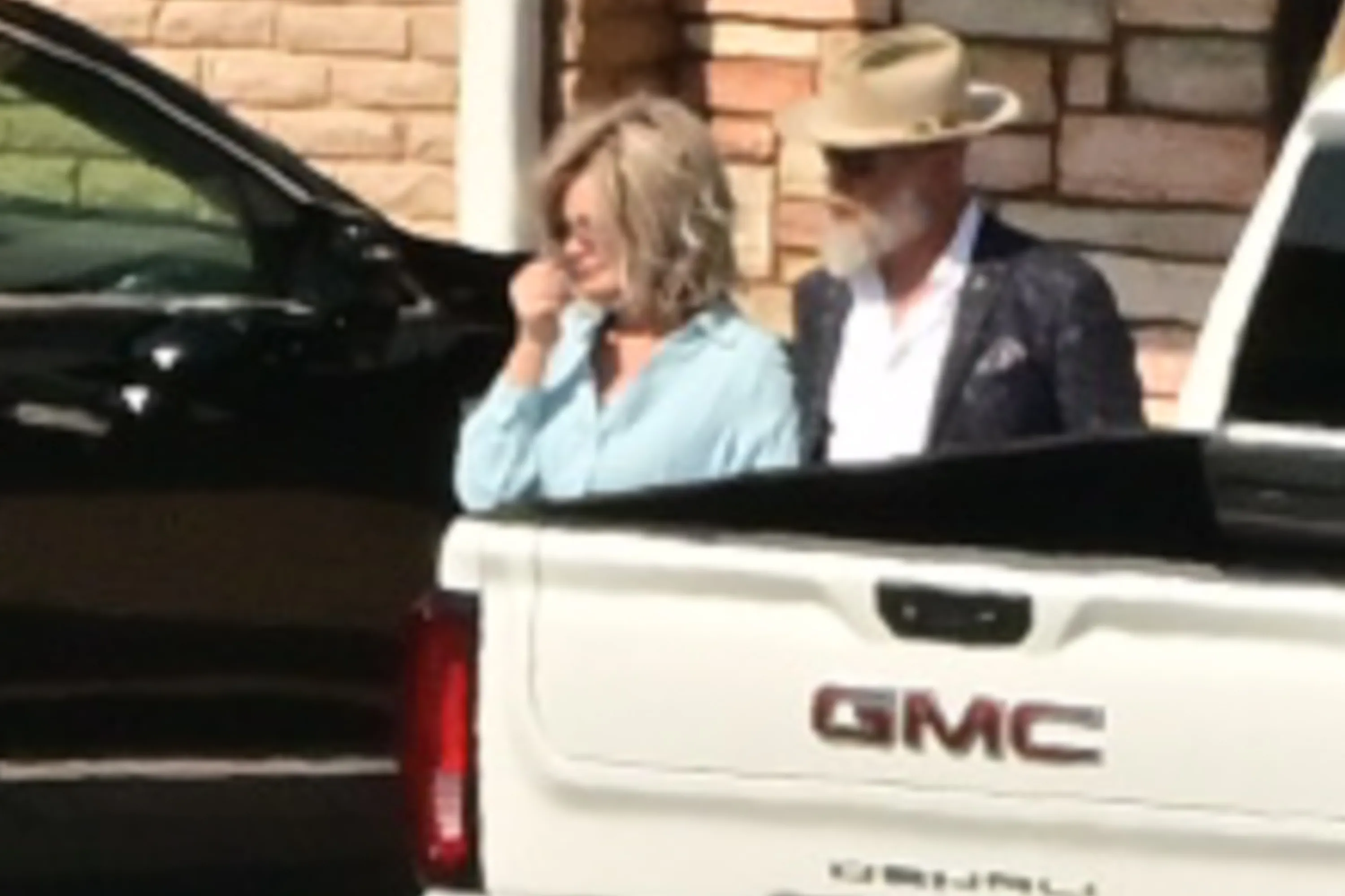 Bryan Seaver, in a fedora, with a woman in sunglasses.