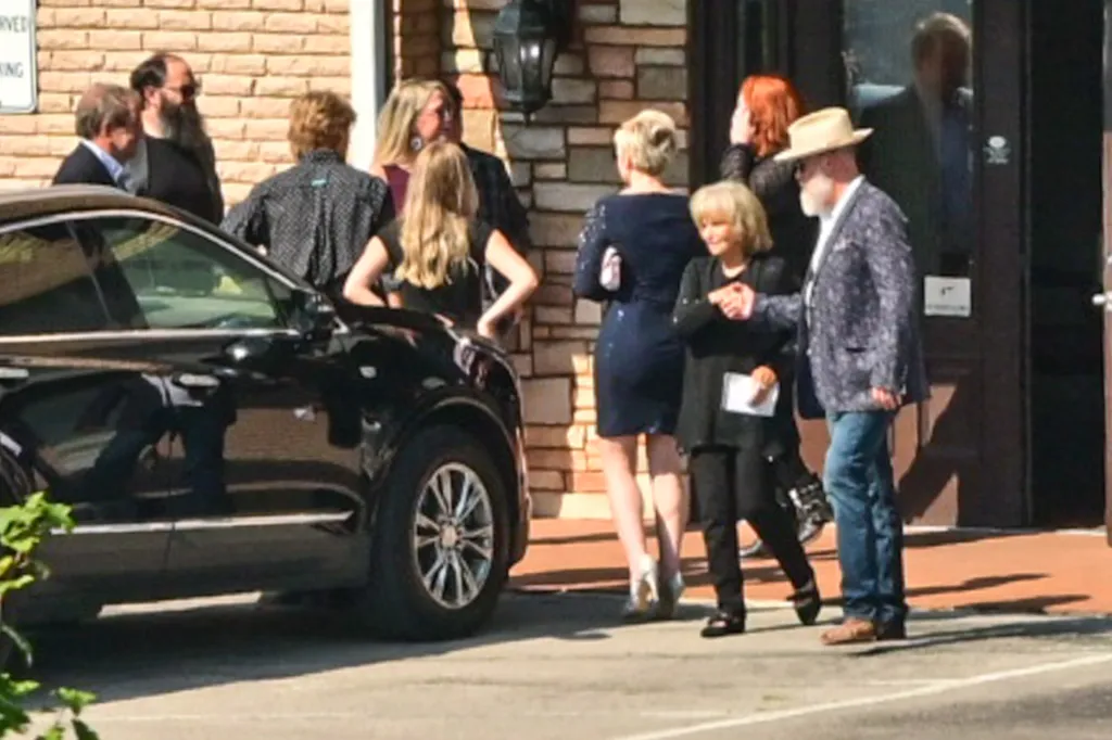 Bryan Seaver with what appears to be Dolly Parton's family at a funeral home.