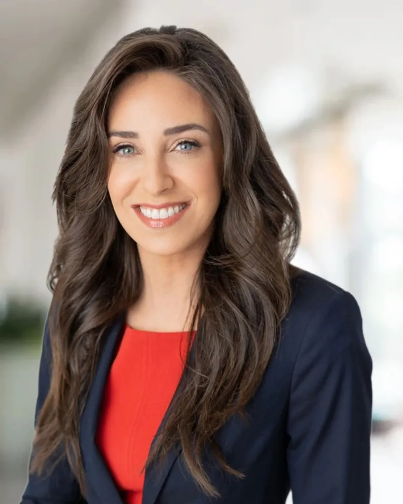 Newport Beach Mayor Lauren Kleiman smiles while wearing a dark blue blazer over a red top.