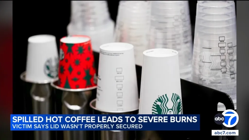 Starbucks cups on a counter with a news banner stating
