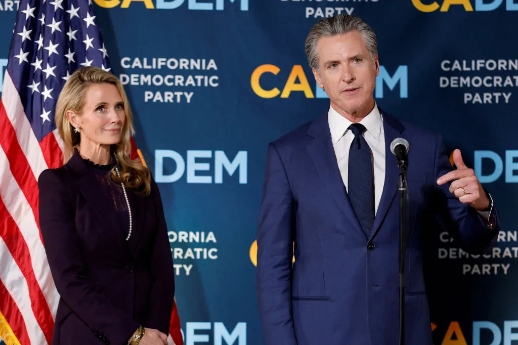 California Governor Gavin Newsom speaks next to his wife Jennifer Siebel Newsom at a special election event in Sacramento.