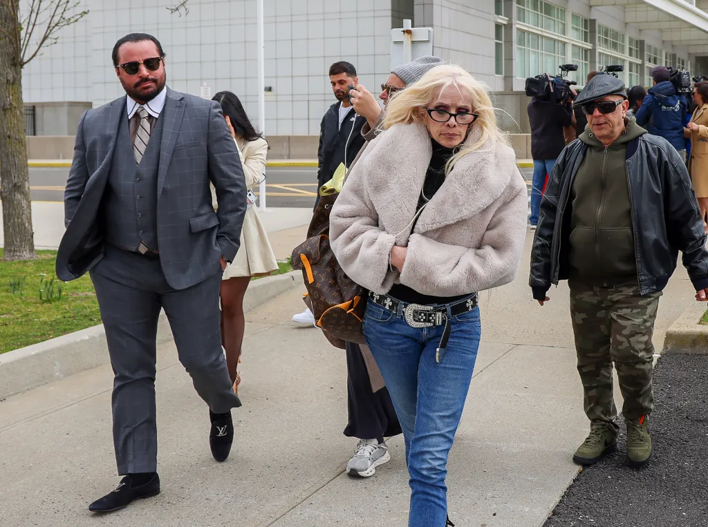 Carmine G. Agnello (left) and his mom Victoria Gotti leave Federal Court.